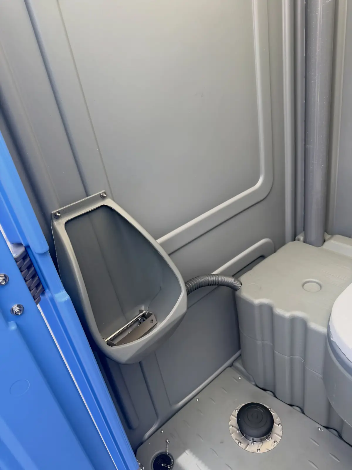 Close-up of the urinal inside a gray standard porta potty