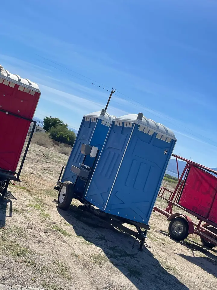 Porta potties on a trailer at a dirt jobsite
