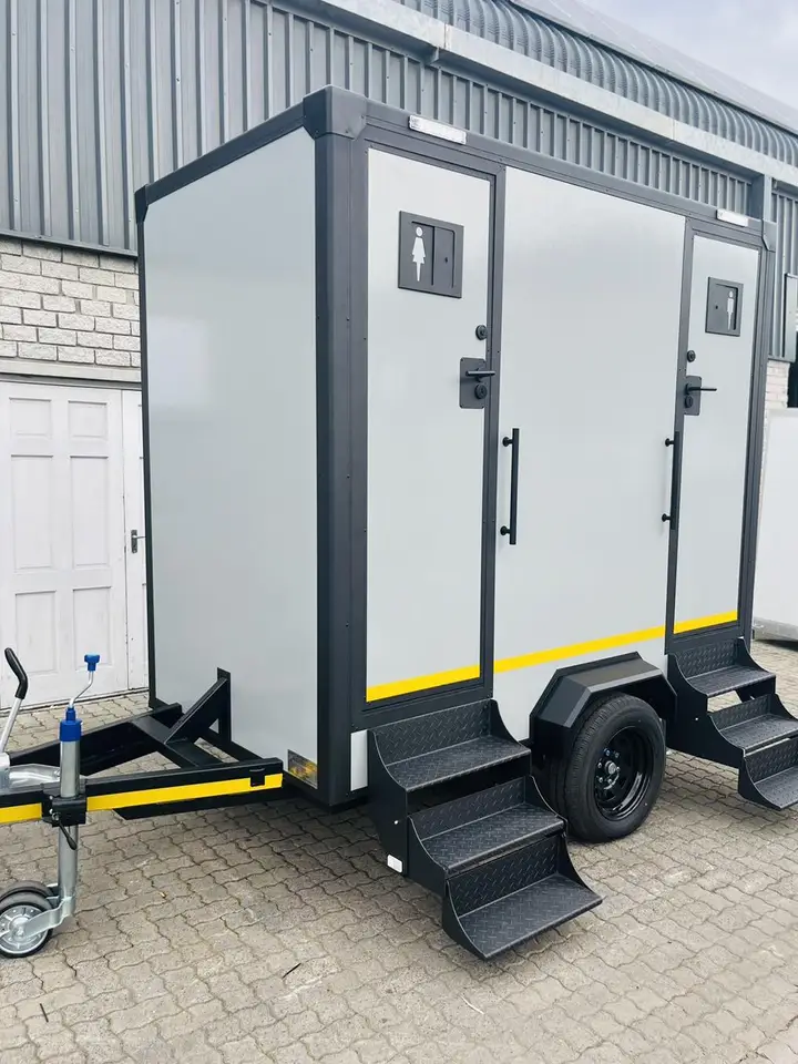 Gray two-stall restroom trailer with steps
