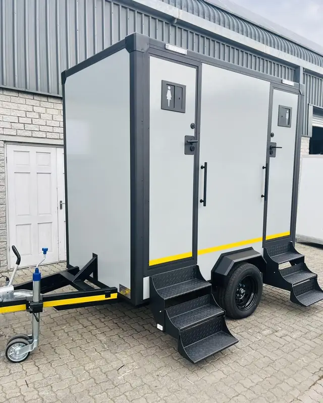 Two-stall restroom trailer with folding steps
